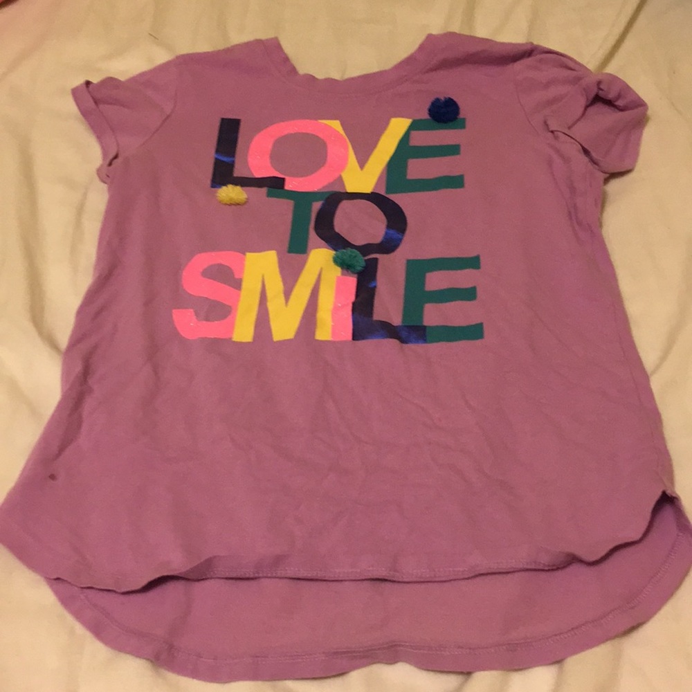 I am selling a cute shirt that says LOVE TO SMiLE.